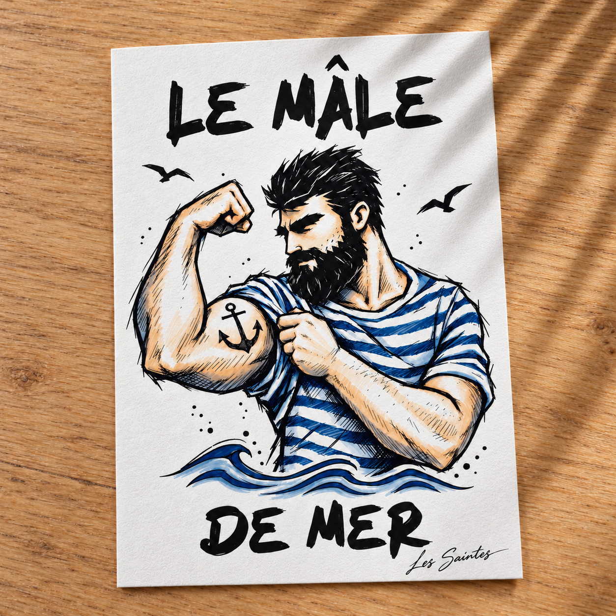 Carte postale — Le Mâle de mer, papier texturé posé sur une table avec une légère ombre de feuillage — Atelier Karaïbes, Les Saintes